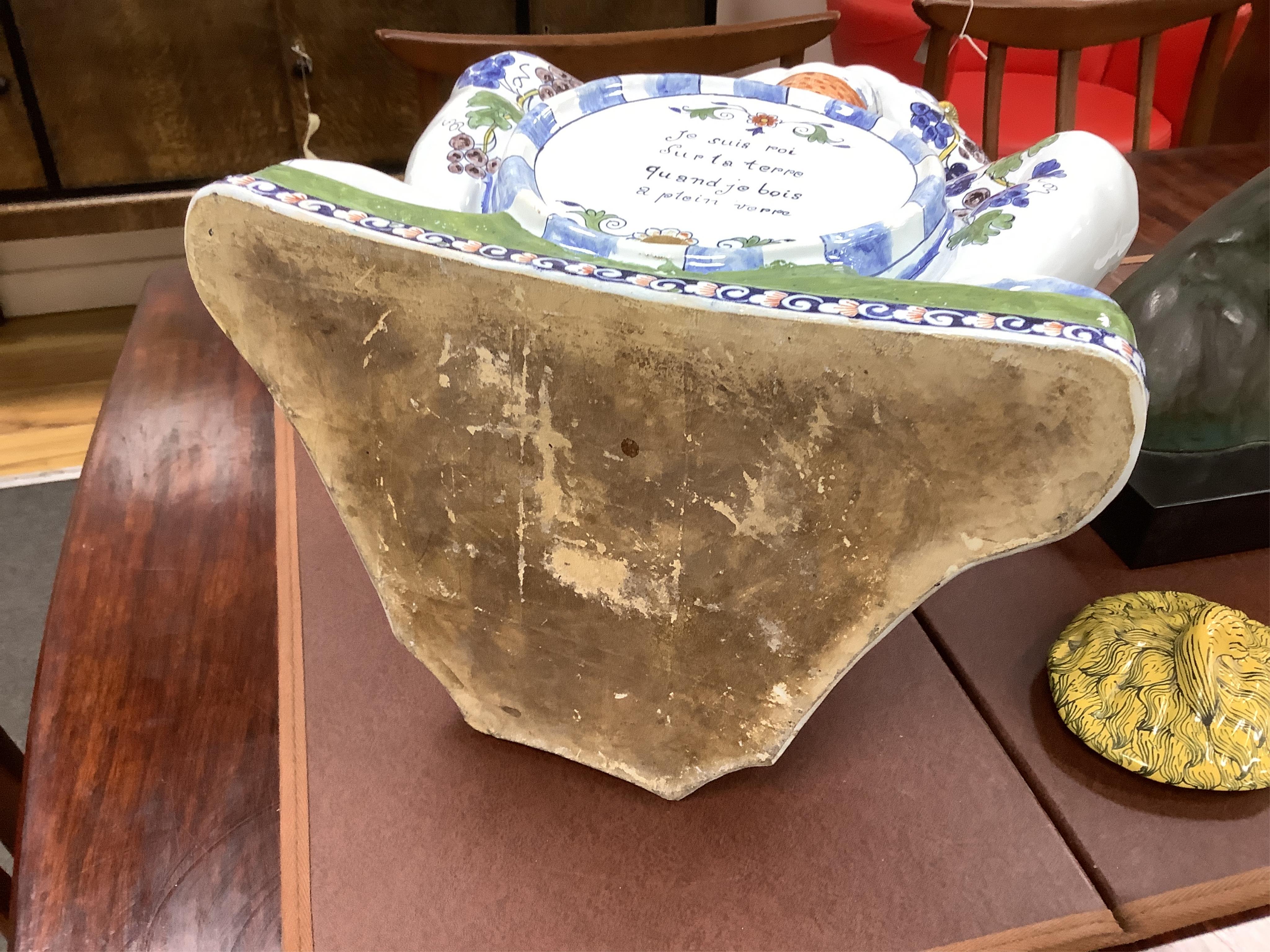 A large Brussels style faience Bacchus figural wine cistern, 62cm high